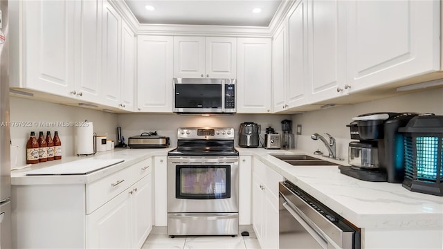 kitchen with white cabinetry, a sink, appliances with stainless steel finishes, and recessed lighting