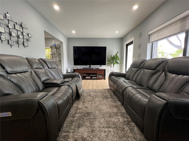 living room with a wealth of natural light, light wood-style floors, and recessed lighting
