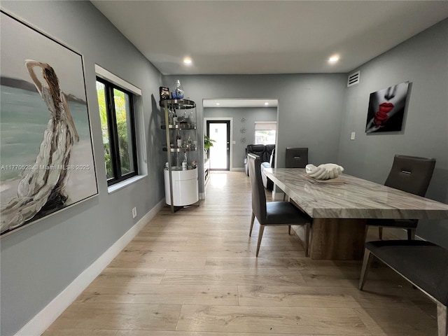dining area with recessed lighting, baseboards, a wealth of natural light, and light wood-style floors