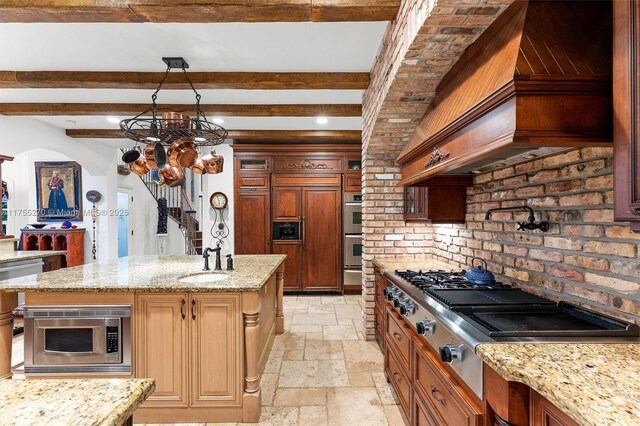 12483 Grand Oaks Dr, Davie, FL 33330 - kitchen featuring stone tile floors, a sink, built in appliances, custom range hood, and beam ceiling