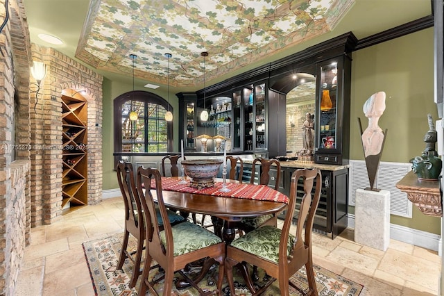 12483 Grand Oaks Dr, Davie, FL 33330 - dining area with stone tile flooring, baseboards, crown molding, and bar area