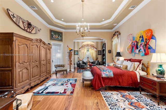 12483 Grand Oaks Dr, Davie, FL 33330 - bedroom featuring a tray ceiling, a chandelier, wood finished floors, arched walkways, and ornamental molding