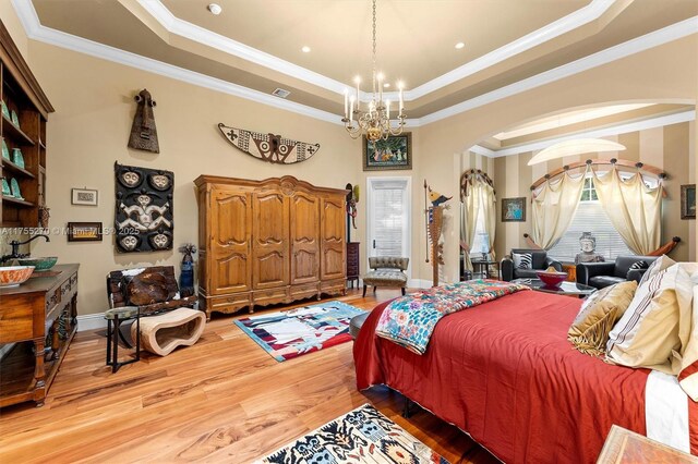 12483 Grand Oaks Dr, Davie, FL 33330 - bedroom with arched walkways, a raised ceiling, a chandelier, light wood-type flooring, and crown molding