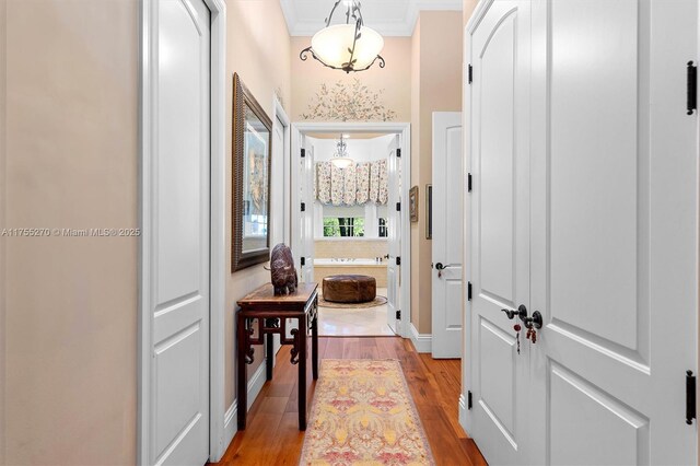 12483 Grand Oaks Dr, Davie, FL 33330 - hallway with wood finished floors, crown molding, and baseboards