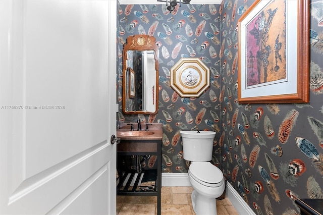 12483 Grand Oaks Dr, Davie, FL 33330 - half bath with baseboards, toilet, wallpapered walls, and vanity