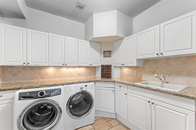12483 Grand Oaks Dr, Davie, FL 33330 - washroom with washing machine and dryer, cabinet space, and stone tile flooring