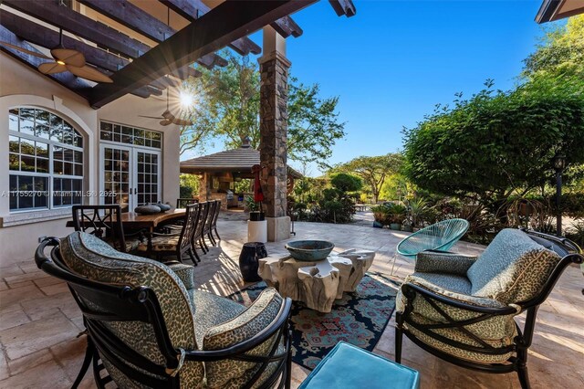12483 Grand Oaks Dr, Davie, FL 33330 - view of patio / terrace with a fire pit, a ceiling fan, outdoor dining space, and french doors