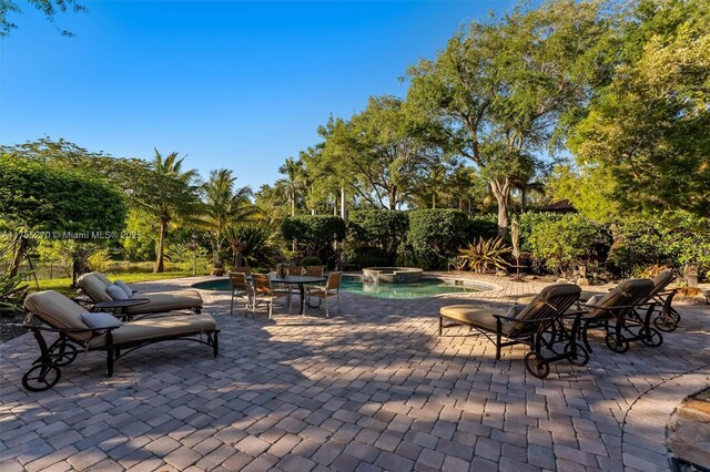 12483 Grand Oaks Dr, Davie, FL 33330 - view of patio / terrace featuring a pool with connected hot tub