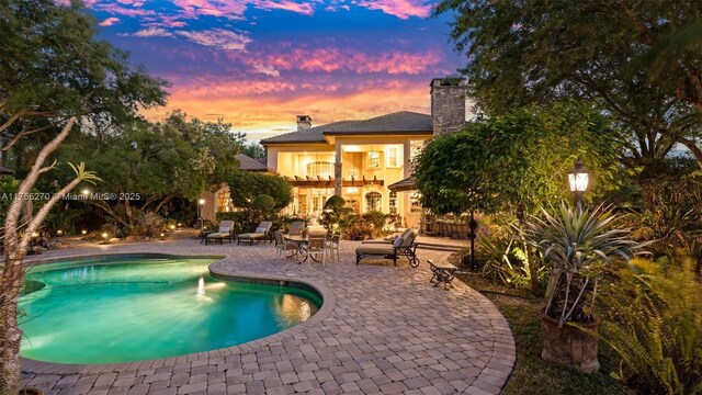 12483 Grand Oaks Dr, Davie, FL 33330 - pool at dusk with a patio area and an outdoor pool