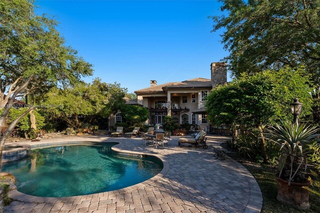 12483 Grand Oaks Dr, Davie, FL 33330 - view of swimming pool with a patio and a pool with connected hot tub