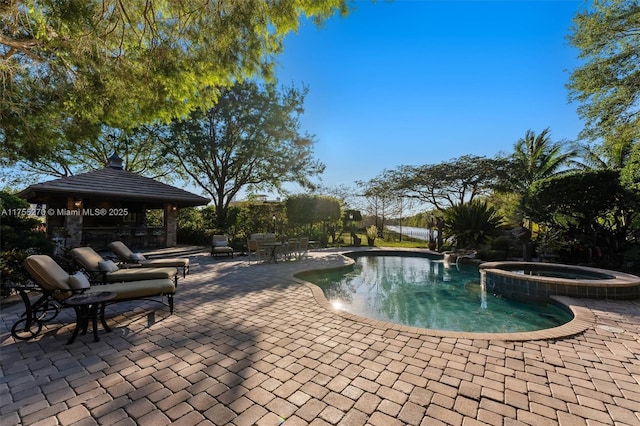 12483 Grand Oaks Dr, Davie, FL 33330 - view of swimming pool featuring a gazebo, a patio area, and a pool with connected hot tub