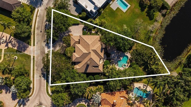 12483 Grand Oaks Dr, Davie, FL 33330 - aerial overview of property's location featuring a pool area, property parcel outlined, and a nearby body of water