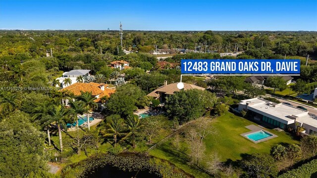 12483 Grand Oaks Dr, Davie, FL 33330 - bird's eye view of a pool area and a heavily wooded area