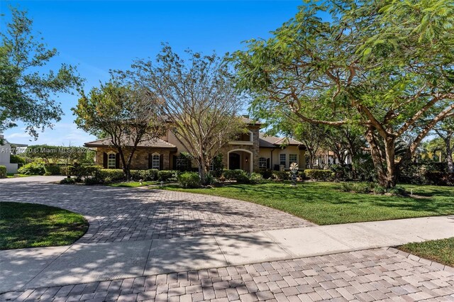 12483 Grand Oaks Dr, Davie, FL 33330 - obstructed view of property featuring a front yard and decorative driveway