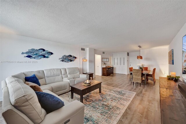 801 S Ocean Dr Unit 604, Hollywood, FL 33019 - living room with a textured ceiling, visible vents, and light wood finished floors