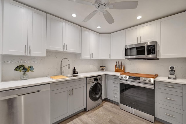 801 S Ocean Dr Unit 604, Hollywood, FL 33019 - kitchen featuring a sink, stainless steel appliances, gray cabinets, and washer / dryer