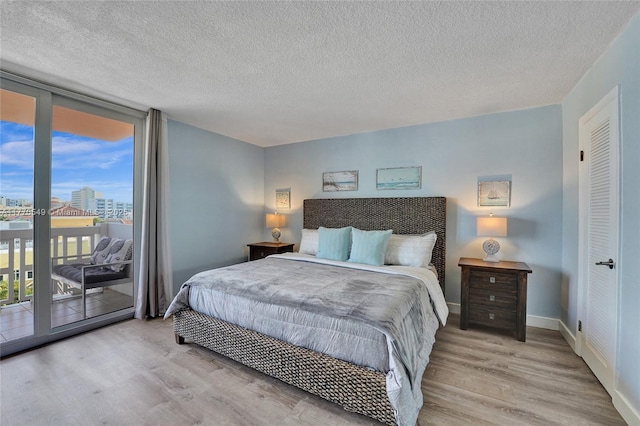 801 S Ocean Dr Unit 604, Hollywood, FL 33019 - bedroom with a city view, light wood finished floors, baseboards, expansive windows, and access to exterior