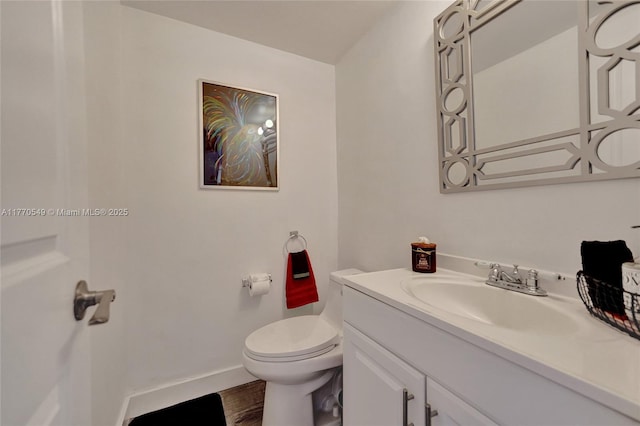 801 S Ocean Dr Unit 604, Hollywood, FL 33019 - half bathroom featuring baseboards, toilet, vanity, and wood finished floors