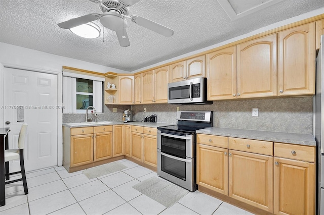 kitchen featuring a sink, light brown cabinets, and appliances with stainless steel finishes
