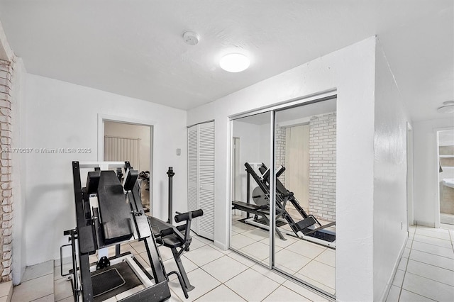 exercise area featuring light tile patterned floors
