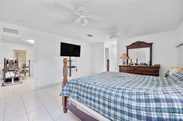 bedroom with baseboards, ceiling fan, visible vents, and light tile patterned floors