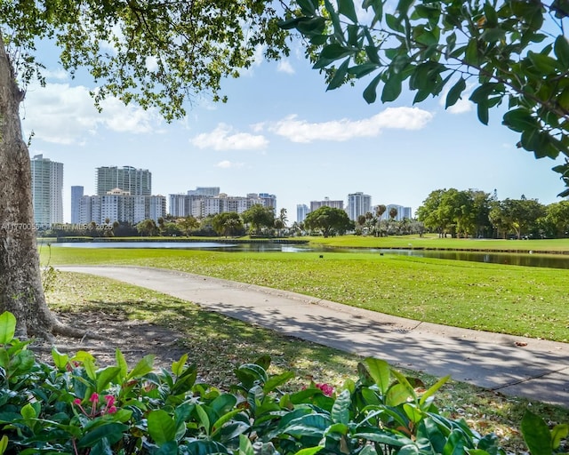 surrounding community with a city view, a water view, and a yard