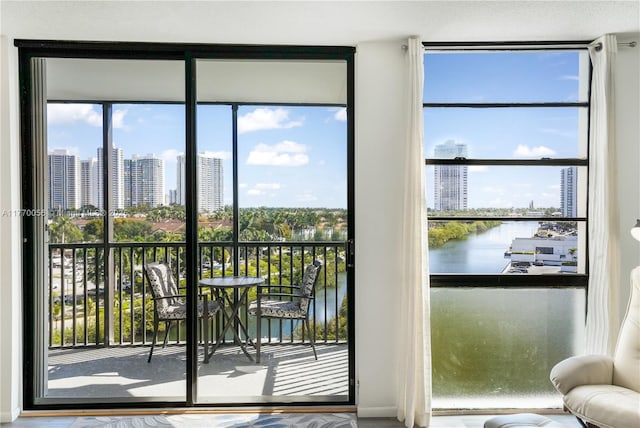 doorway with a view of city, a water view, and plenty of natural light