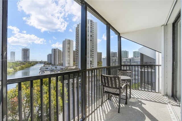 balcony featuring a water view and a view of city