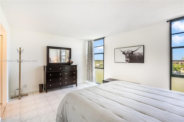 tiled bedroom featuring multiple windows