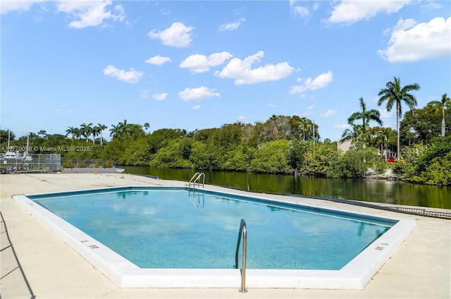view of swimming pool with a water view