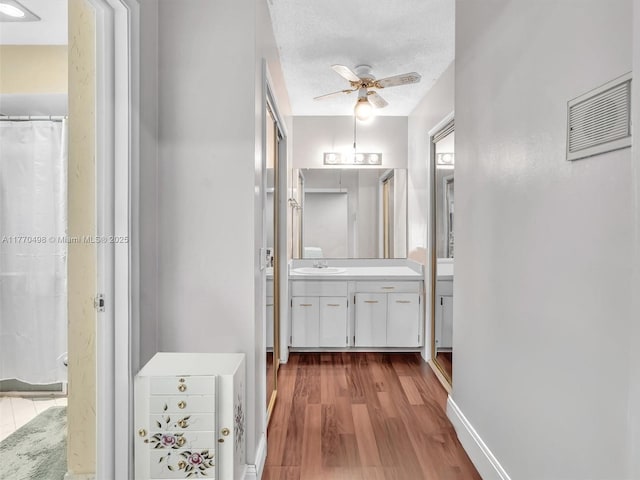 5404 Bayberry Ln, Tamarac, FL 33319 - corridor featuring wood finished floors, a sink, and baseboards
