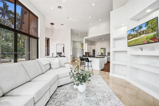 3320 Bridle Path Ln, Weston, FL 33331 - living area featuring built in features, recessed lighting, a high ceiling, and french doors