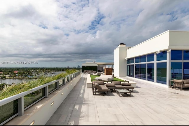 view of patio / terrace with an outdoor hangout area and a water view