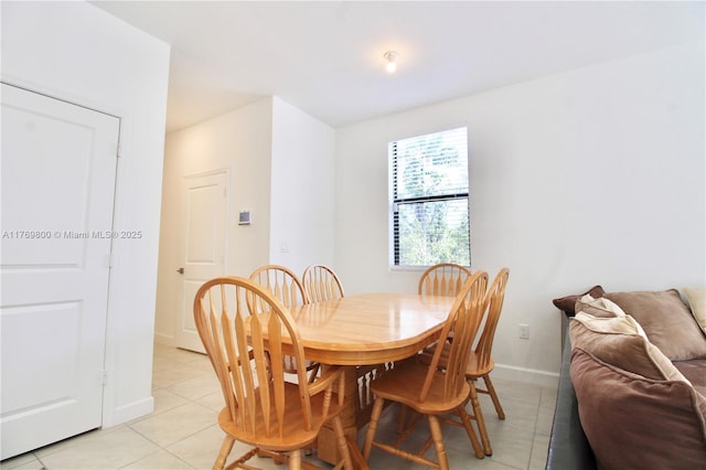 dining room featuring baseboards and light tile patterned floors