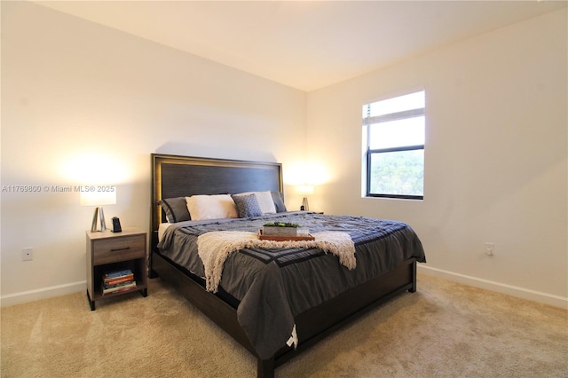 bedroom featuring light carpet and baseboards