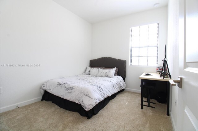 carpeted bedroom featuring baseboards