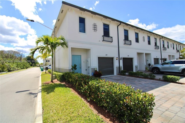 view of building exterior with driveway and an attached garage