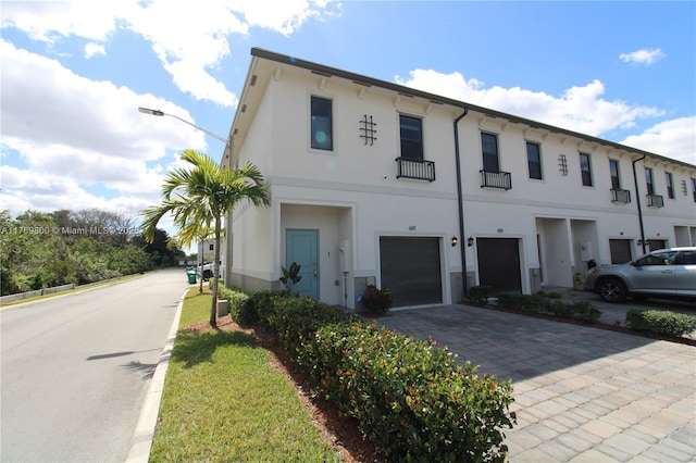view of building exterior featuring driveway and an attached garage