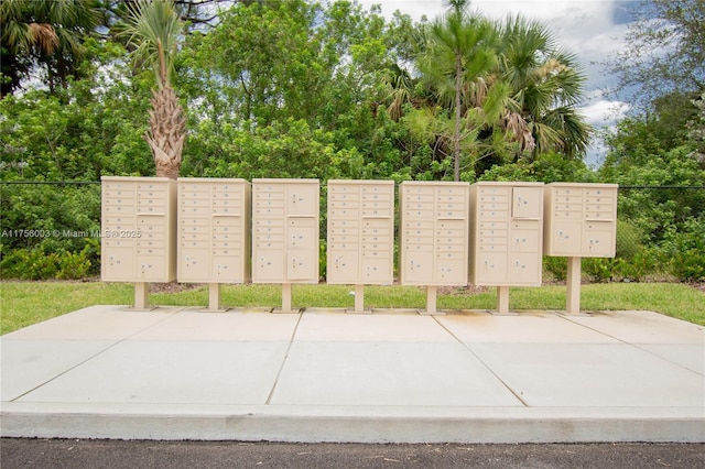 view of property's community with fence and mail area