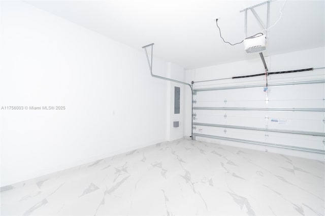 garage featuring electric panel, a garage door opener, and baseboards