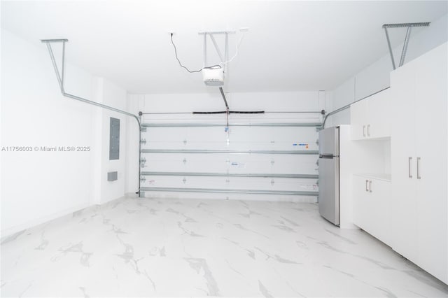 garage featuring freestanding refrigerator, a garage door opener, and electric panel