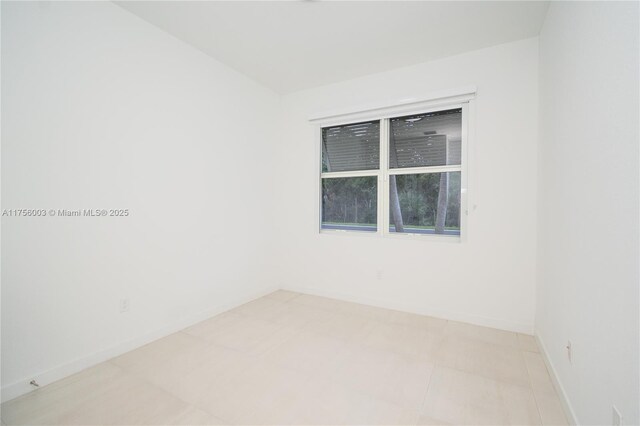 unfurnished room featuring baseboards