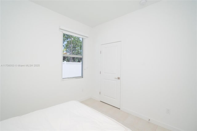 unfurnished bedroom featuring baseboards