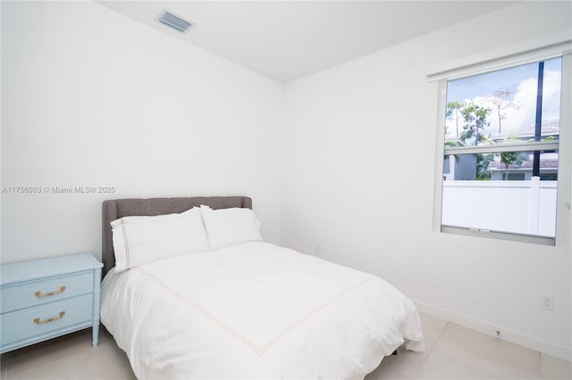 bedroom with baseboards, visible vents, and tile patterned flooring
