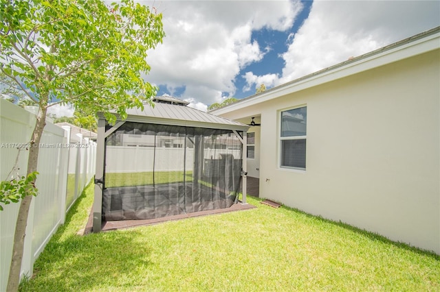 view of yard featuring a fenced backyard and a gazebo