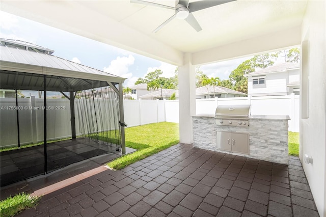 view of patio / terrace featuring area for grilling, a fenced backyard, a gazebo, grilling area, and a ceiling fan