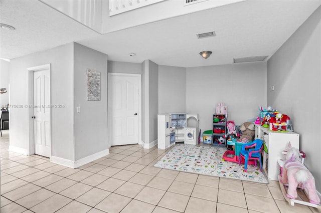 rec room featuring visible vents, baseboards, and light tile patterned flooring