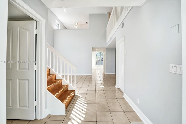 2791 La Paz Ave, Cooper City, FL 33026 - foyer featuring light tile patterned floors, a ceiling fan, stairs, and a high ceiling