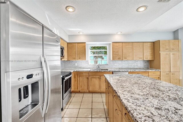 2791 La Paz Ave, Cooper City, FL 33026 - kitchen with appliances with stainless steel finishes, light tile patterned flooring, backsplash, and light stone counters
