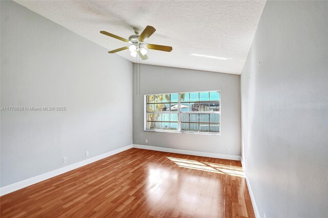 2791 La Paz Ave, Cooper City, FL 33026 - spare room featuring wood finished floors, a ceiling fan, and vaulted ceiling